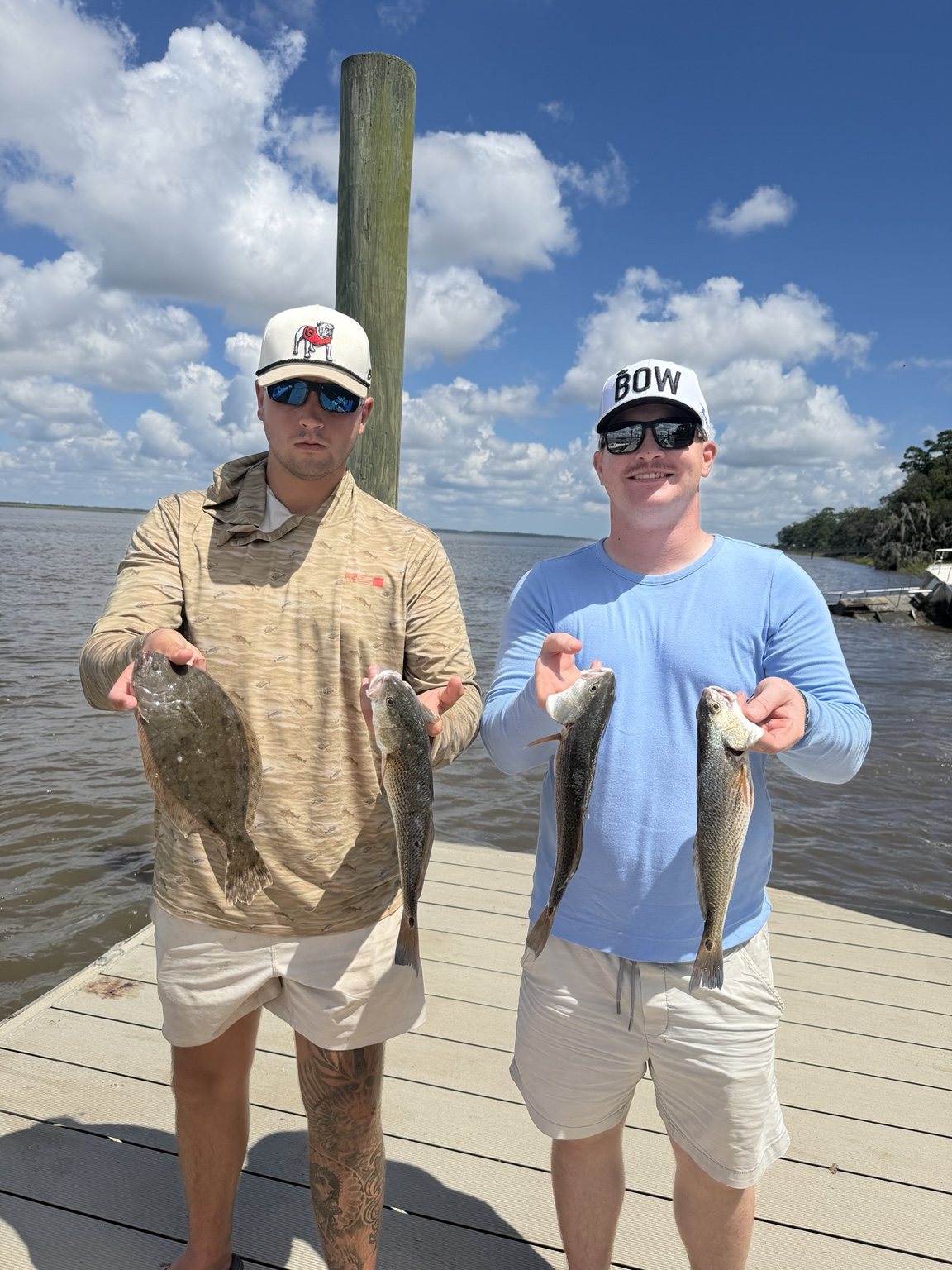 Two anglers holding their catch